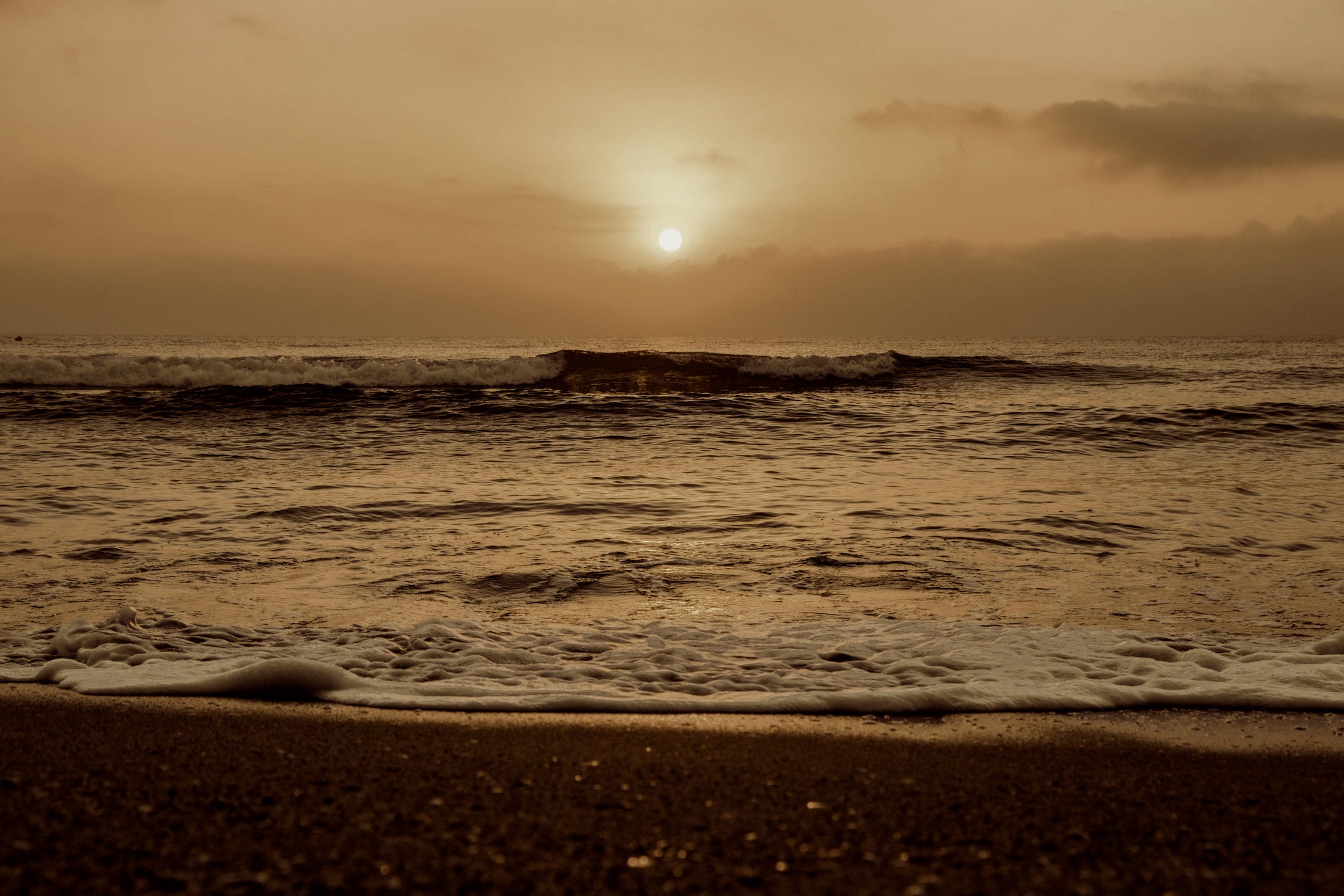sunrise-over-wavy-ocean-on-sandy-beach-1.jpg